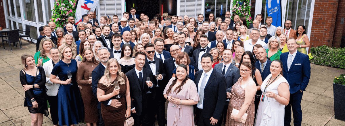 Why Choose Us - Our Values page from Rentokil Initial displaying employees celebrating an award, representing achievement, teamwork and company values.